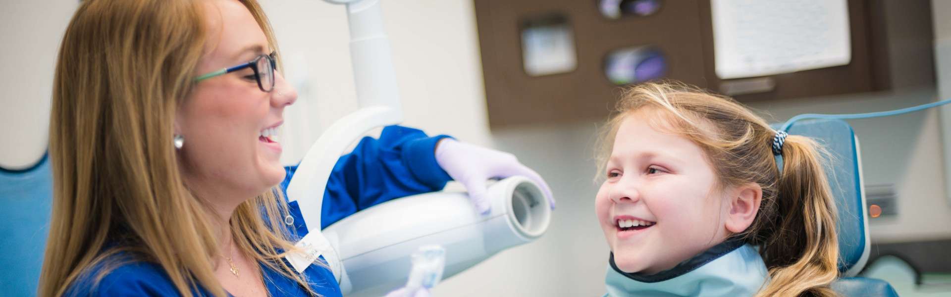 Dental Assistant taking X-rays of young patient